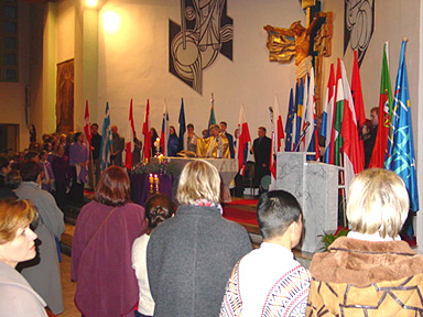 The standards of all the delegations surrounding the altar.