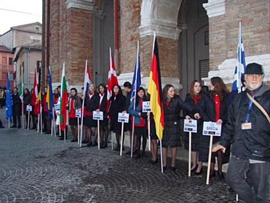 placard-bearers await the delegations as they leave the town hall.