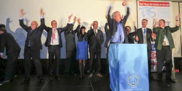 laus Enengl directs a deafening ‘whoo’ chant on the platform and from the audience.