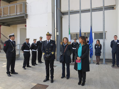 A solemn moment: the flags are raised by sailors of the Italian Navy