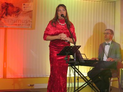 Singer Diana Pirägs, dressed all in red 