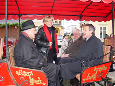 the dignitaries travel in the open carriage