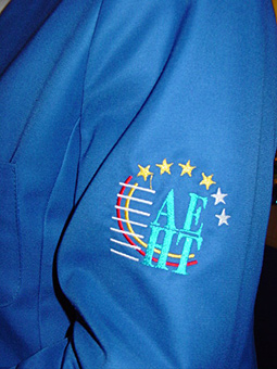 AEHT logo, also at the sleeve of student's uniform.