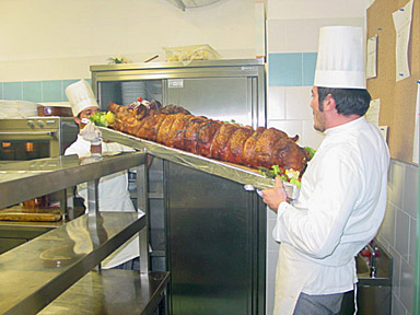 The roasted calf is shown off to the diners before being carved