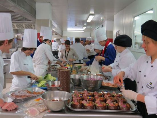 The throng of students in the kitchens preparing the dishes they will present