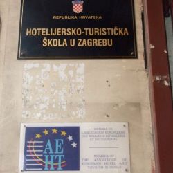 The plaque of the Zagreb Hotel School sits beside the AEHT plaque