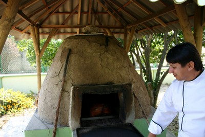 Martin Ospina explaining us how to cook in a clay oven